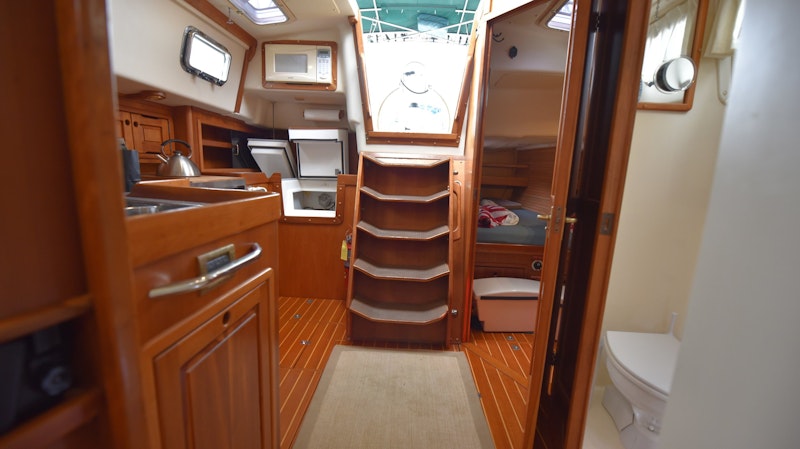 Looking aft from the salon: head to port and Rev&#39;s berth aft of the head. Kitchen on the starboard side.